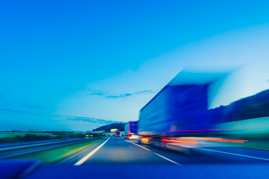 trucks on highway at dusk