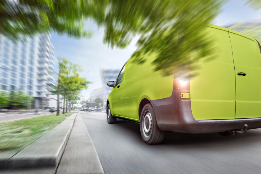 green truck driving into city