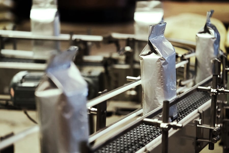 Silver package on a conveyor belt at a co-packer facility