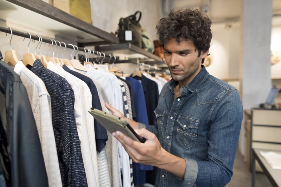 male retail employee manages inventory on the sales floor