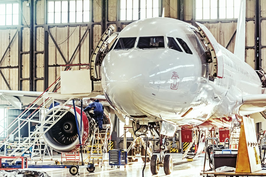 Plane undergoing maintenance in a hangar