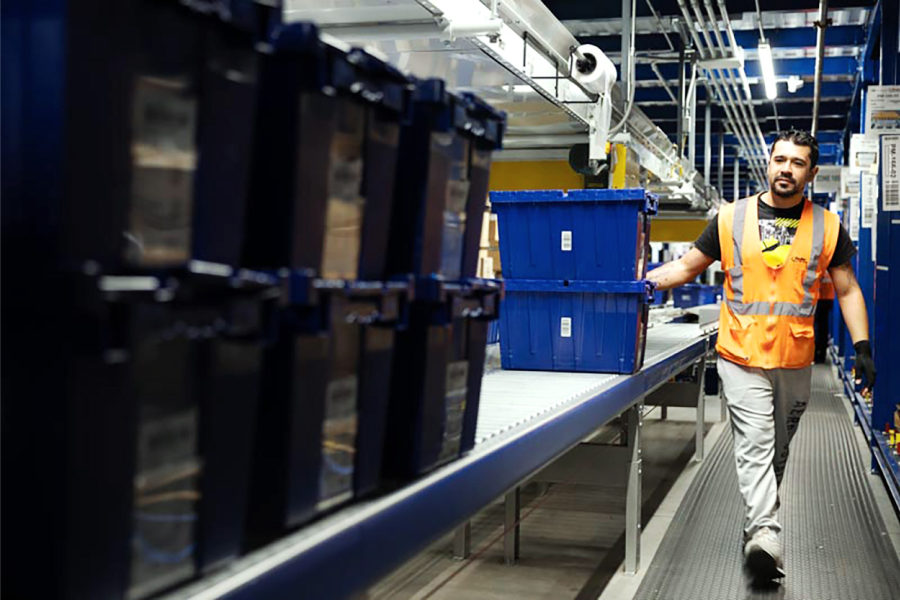 fulfillment center worker stacking boxes