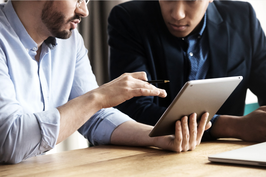 two men looking at tablet discussing freight visibility